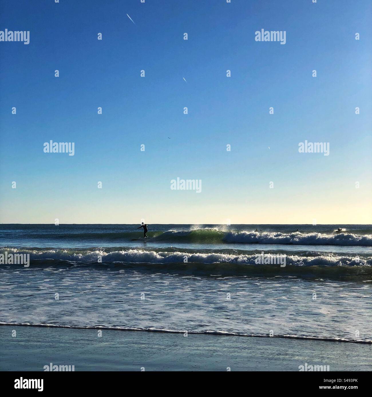 The surfer riding waves at Cabedelo Beach in Portugal, December 2023 - Smartphone Captured Stock Image