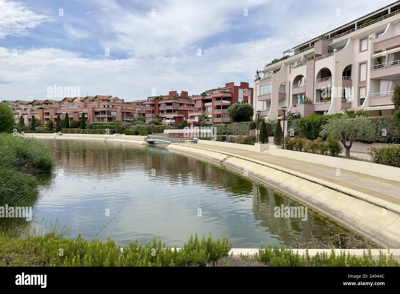 Landscape shot of modern residential buildings around an artificial lake or canal in Lattes, Occitanie, France. - Smartphone Captured Stock Image