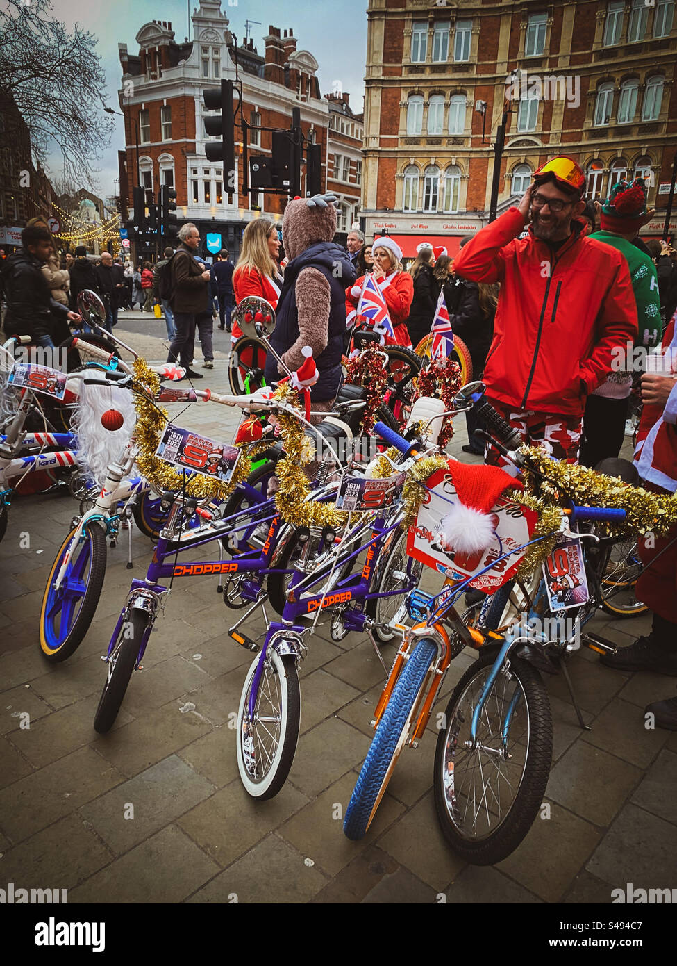 Classic retro bikes are covered in tinsel in a busy part of central London in the UK Stock Photo