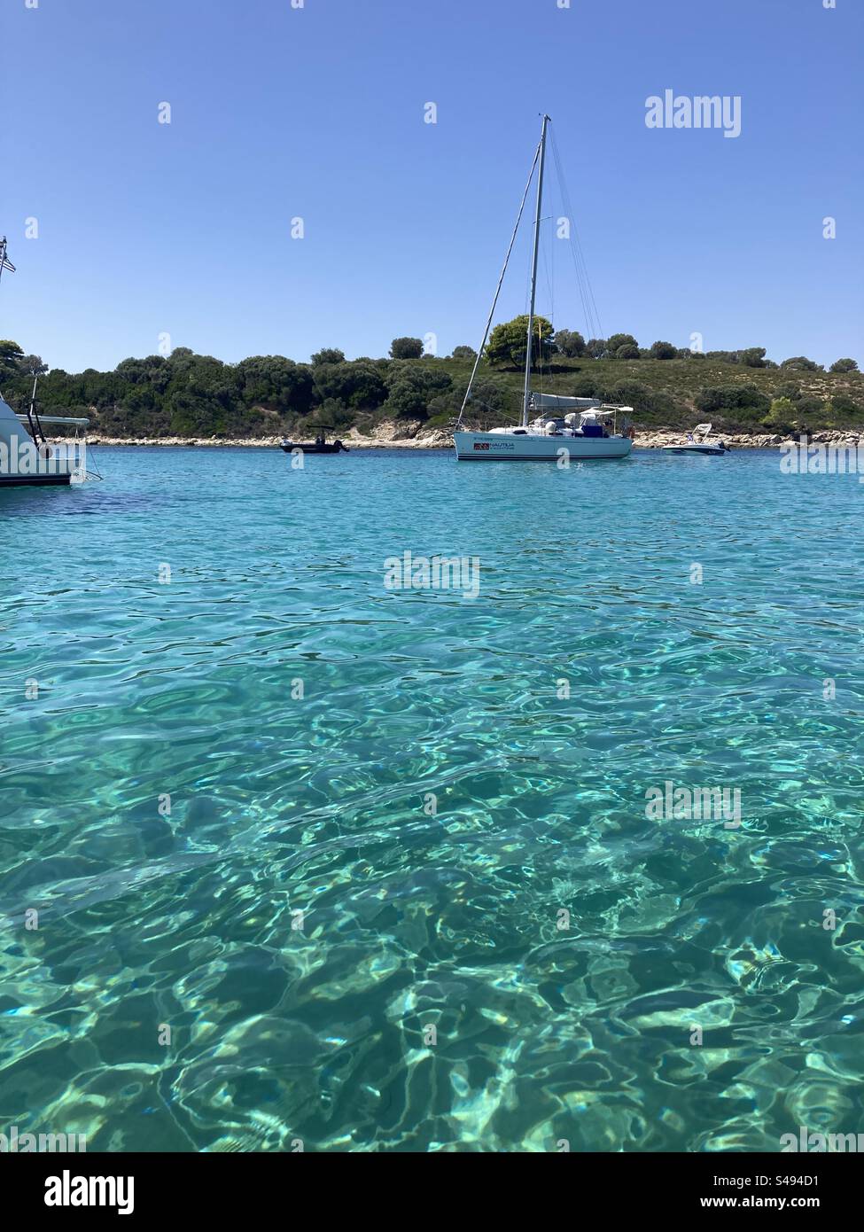 Crystal clear water in the Blue Lagoon near Vourvourou in Sithonia, Halkidiki, Greece - Smartphone Captured Stock Image