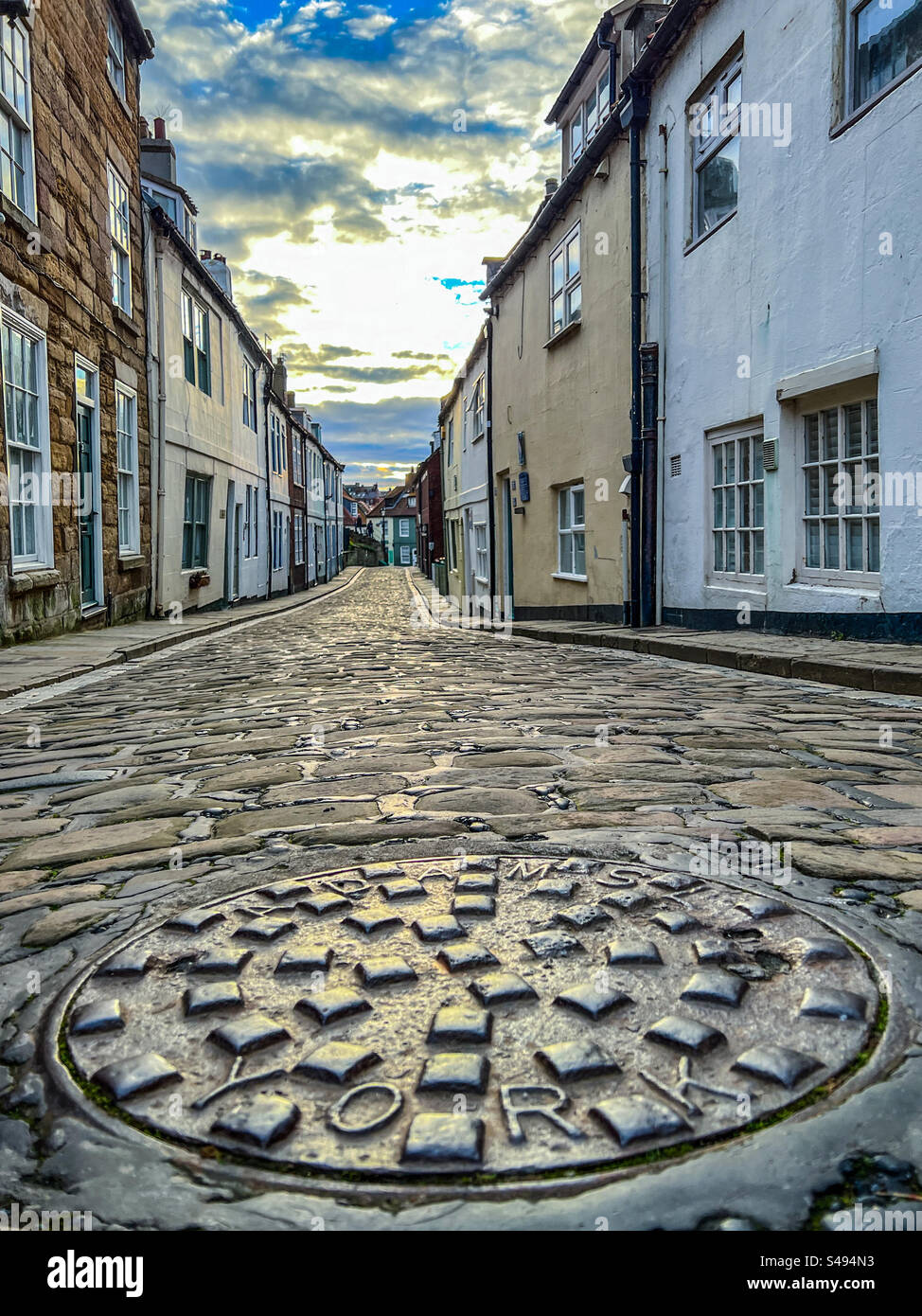 Cobblestone street and quaint houses on Henrietta Street in Whitby