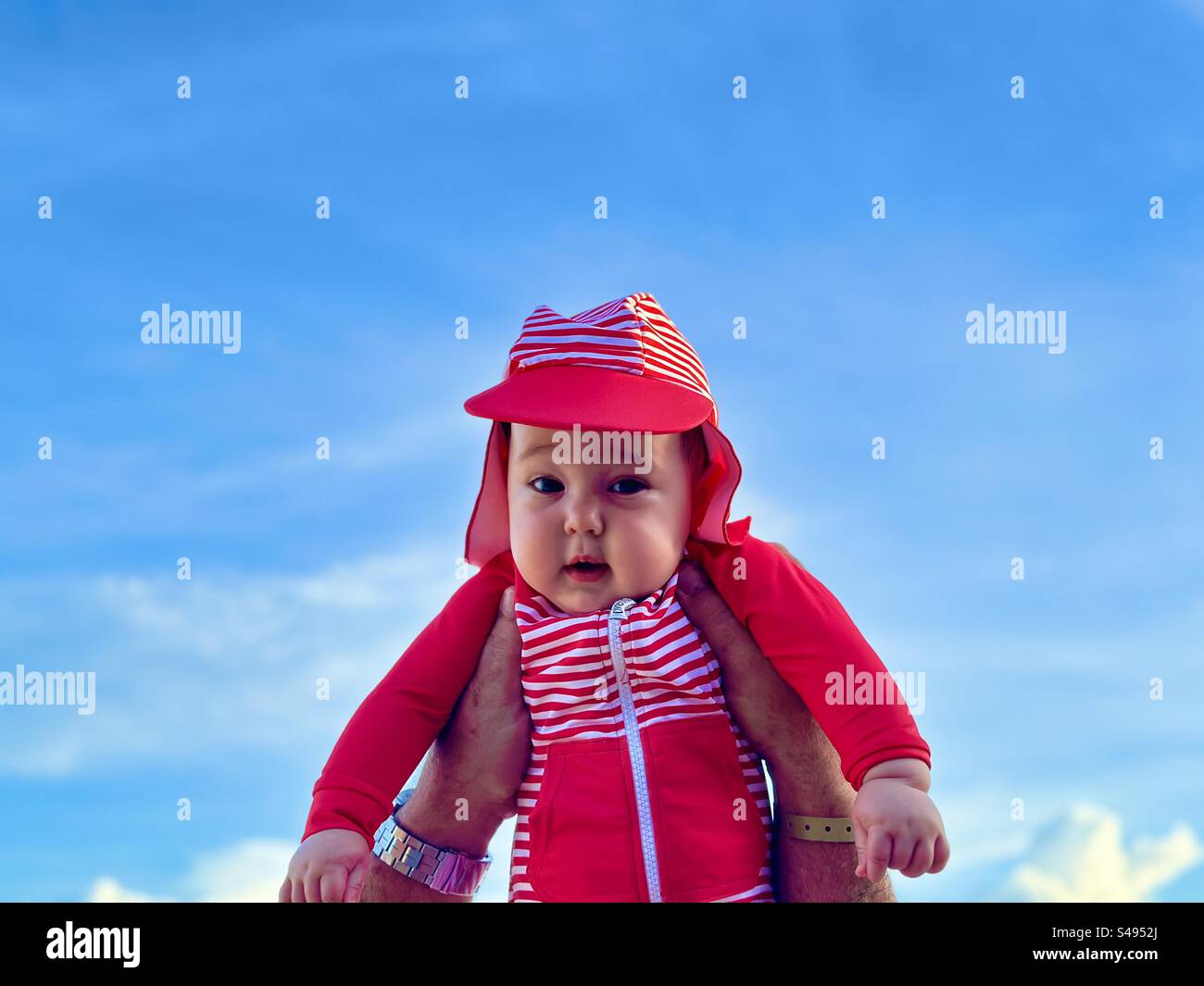 8 month old baby against blue sky. - Smartphone Captured Stock Image