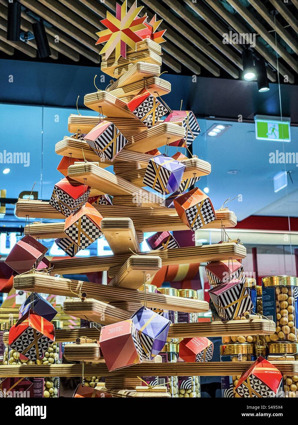 Wooden Christmas tree with gift boxes of chocolates display in chocolate store, Koko Black in Melbourne, Victoria, Australia. - Smartphone Captured Stock Image