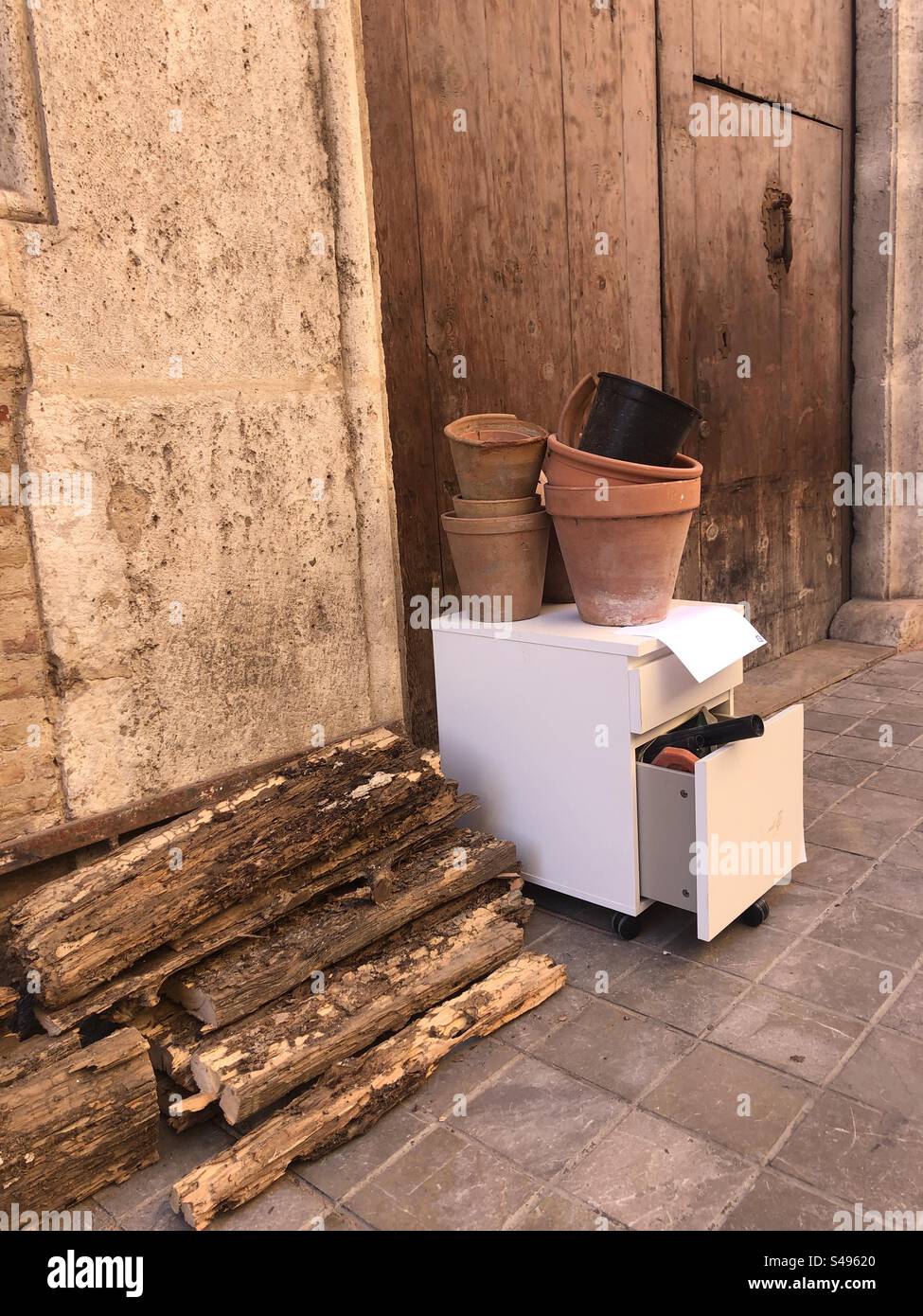 Discarded flowerpots and some furniture left on the street of Valencia Spain - Smartphone Captured Stock Image