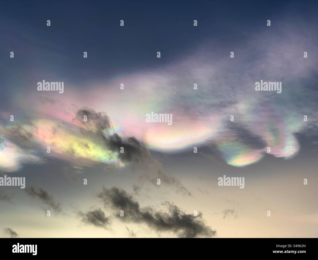 A rare winter phenomenon Nacreous cloud seen over England UK. One of the highest clouds in our atmosphere, also known as Rainbow cloud, mother-of-pearl cloud and Polar stratospheric clouds. Stock Photo