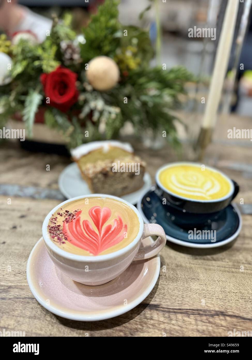 Rose and Turmeric Lattes with Lemon and Chocolate and Nuts Cakes at Remi Flower and Coffee shop in New York City Stock Photo