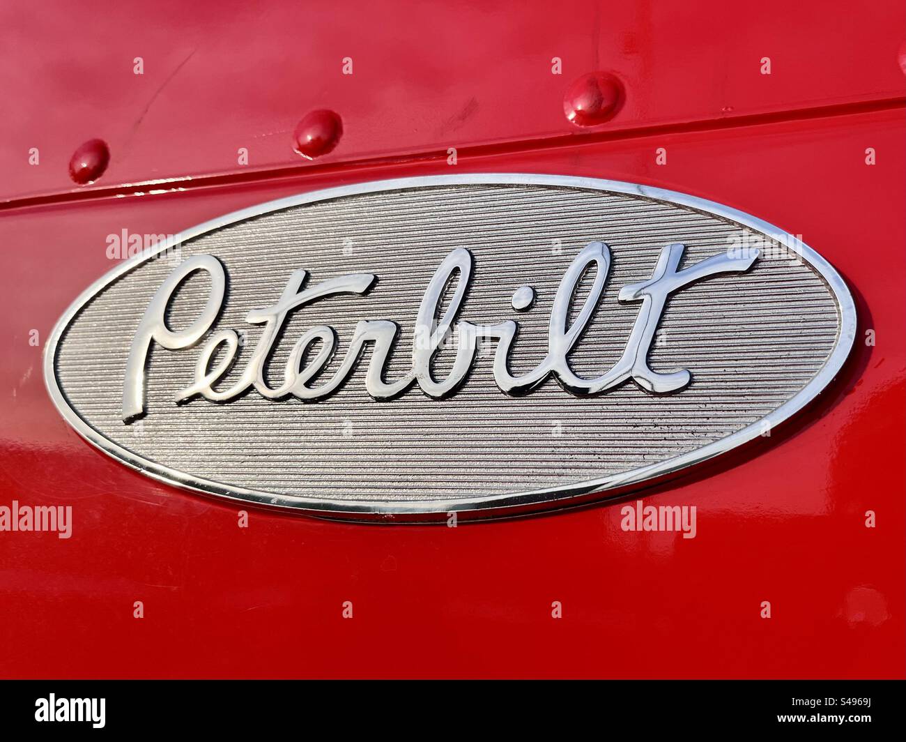 Peterbilt emblem logo and symbol close up detail for the iconic US truck on red - Smartphone Captured Stock Image