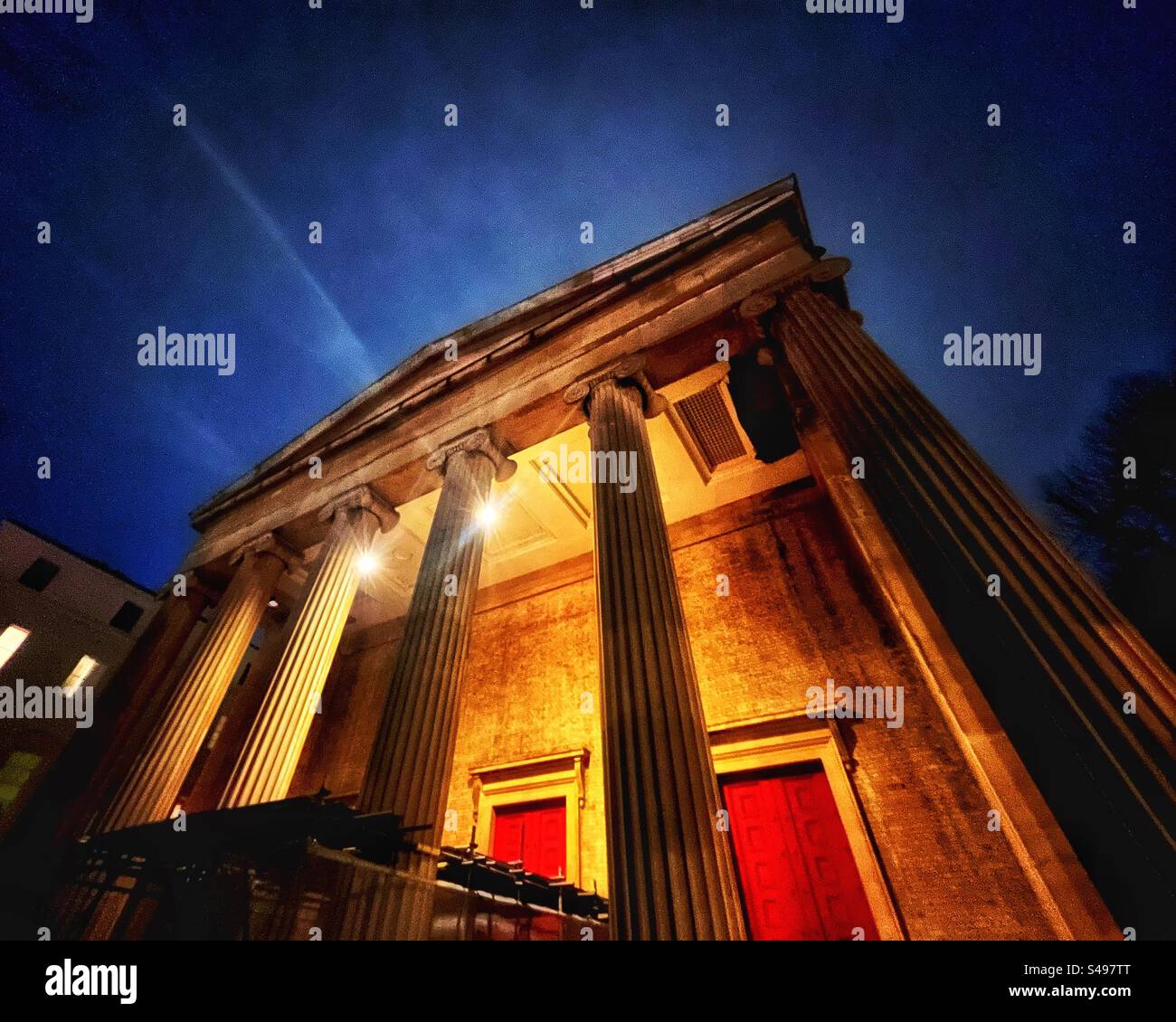St Peter's Church, Eaton Square, London, SW1. Is a neoclassical building designed by the architect Henry Hakewill with a hexastyle portico with Ionic columns and a clock tower.Here at nightfall. Stock Photo