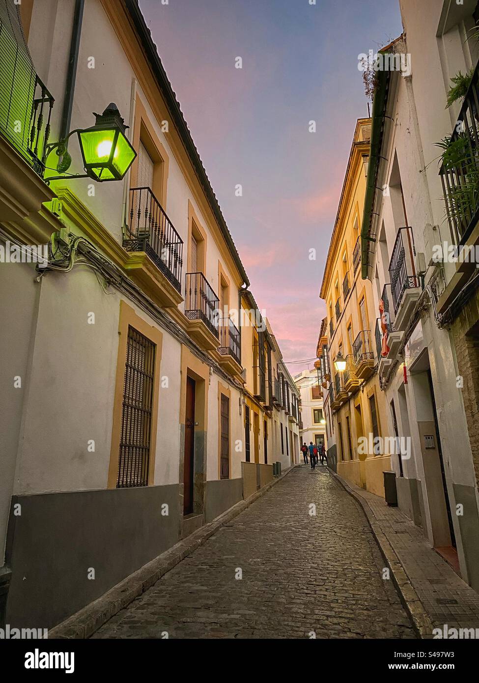 Picturesque narrow street in the evening in Córdoba, Spain. - Smartphone Captured Stock Image