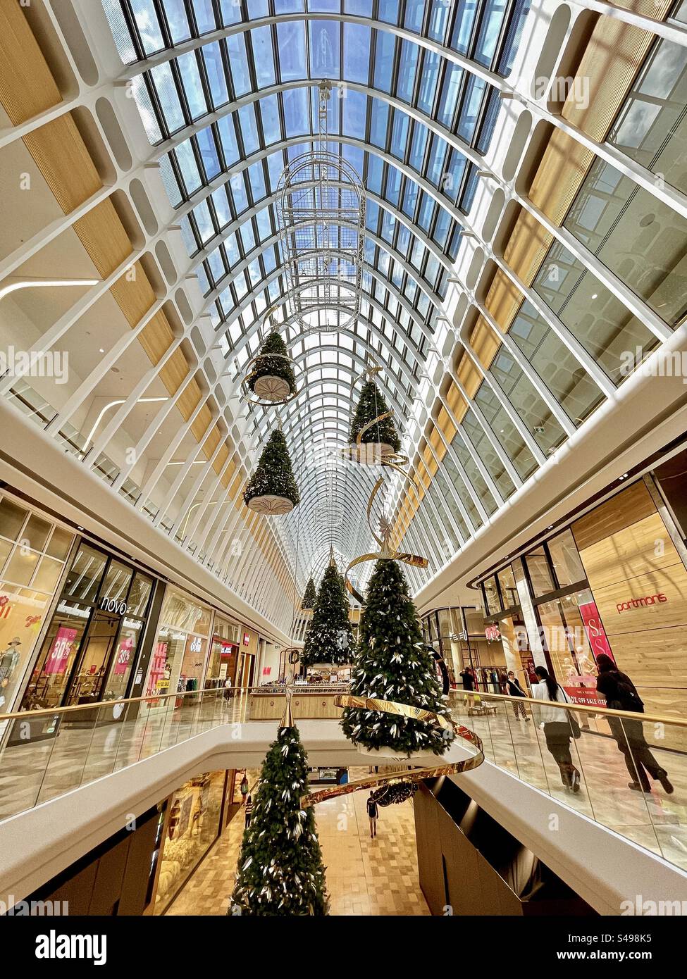 Christmas trees hanging from the skylight of a shopping mall in Melbourne, Victoria, Australia. Retail. Interior design. Consumerism. - Smartphone Captured Stock Image