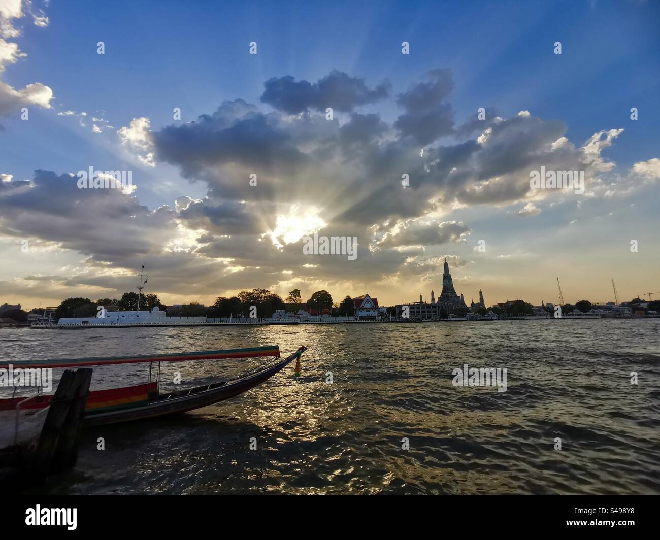 A beautiful sunset over the Chao Phraya river and Wat Arun in Bangkok. - Smartphone Captured Stock Image