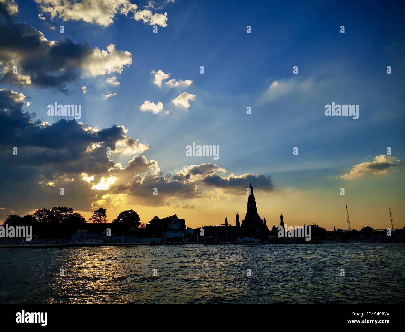 A beautiful sunset over the Chao Phraya river and Wat Arun in Bangkok. - Smartphone Captured Stock Image
