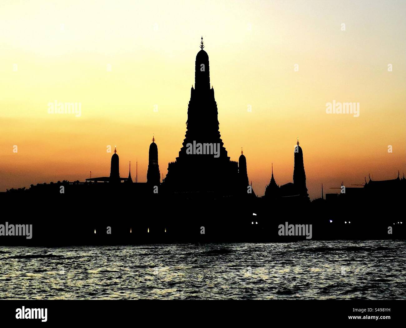 A beautiful sunset over the Chao Phraya river and Wat Arun in Bangkok. - Smartphone Captured Stock Image