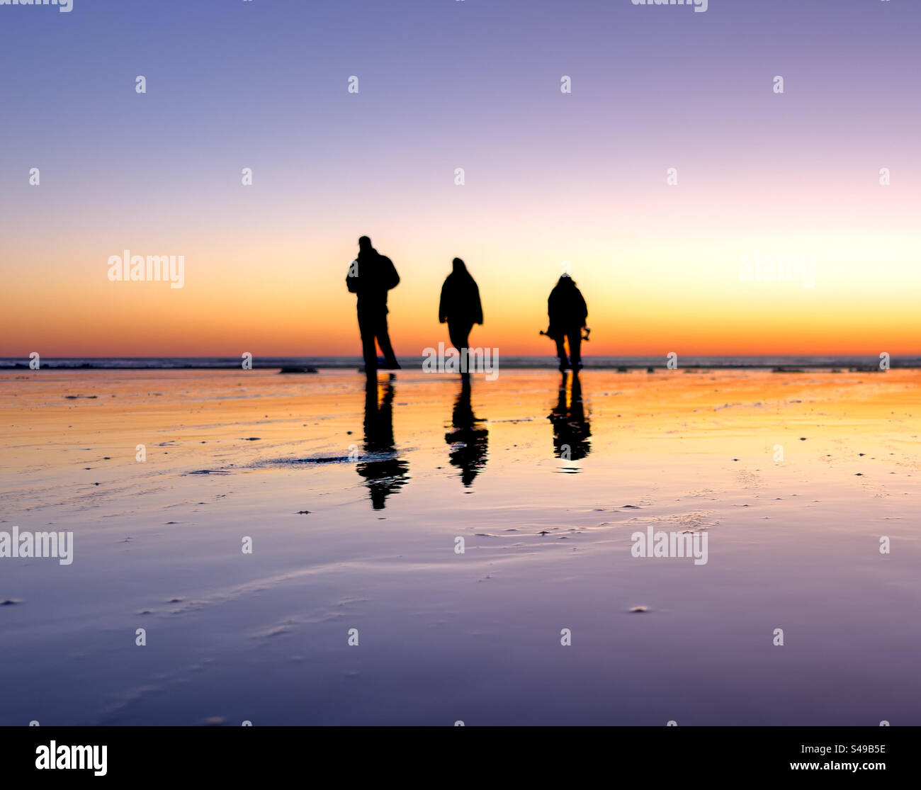 Sunset stroll on the beach Stock Photo