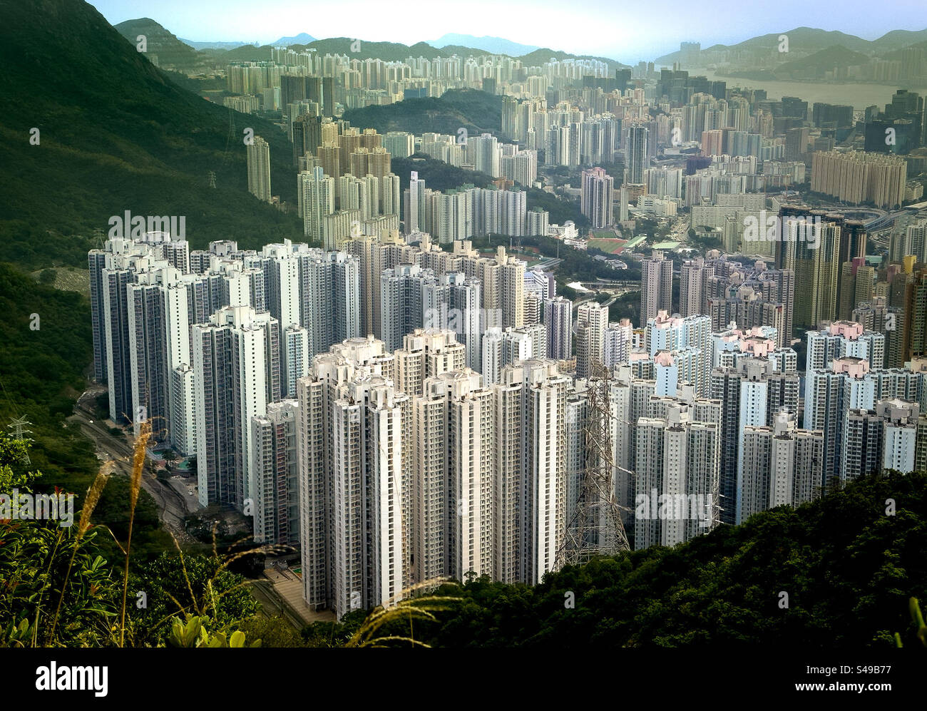 Skyline of Wong Tai Sin district and Tsz Wan Shan in Hong Kong front the Lion Rock peak - Smartphone Captured Stock Image