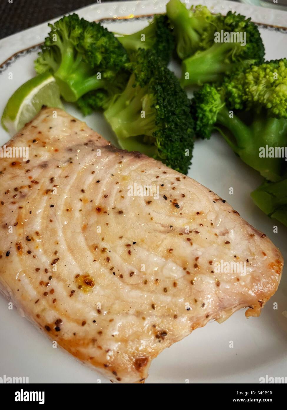 Close up of a broiled swordfish steak and broccoli, 2024, United States