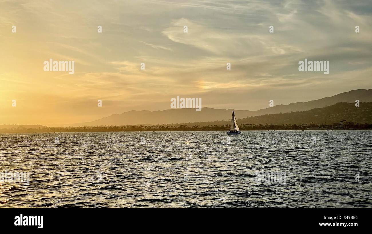 A sailboat on the ocean at sunset in front of Santa Barbara, California - Smartphone Captured Stock Image