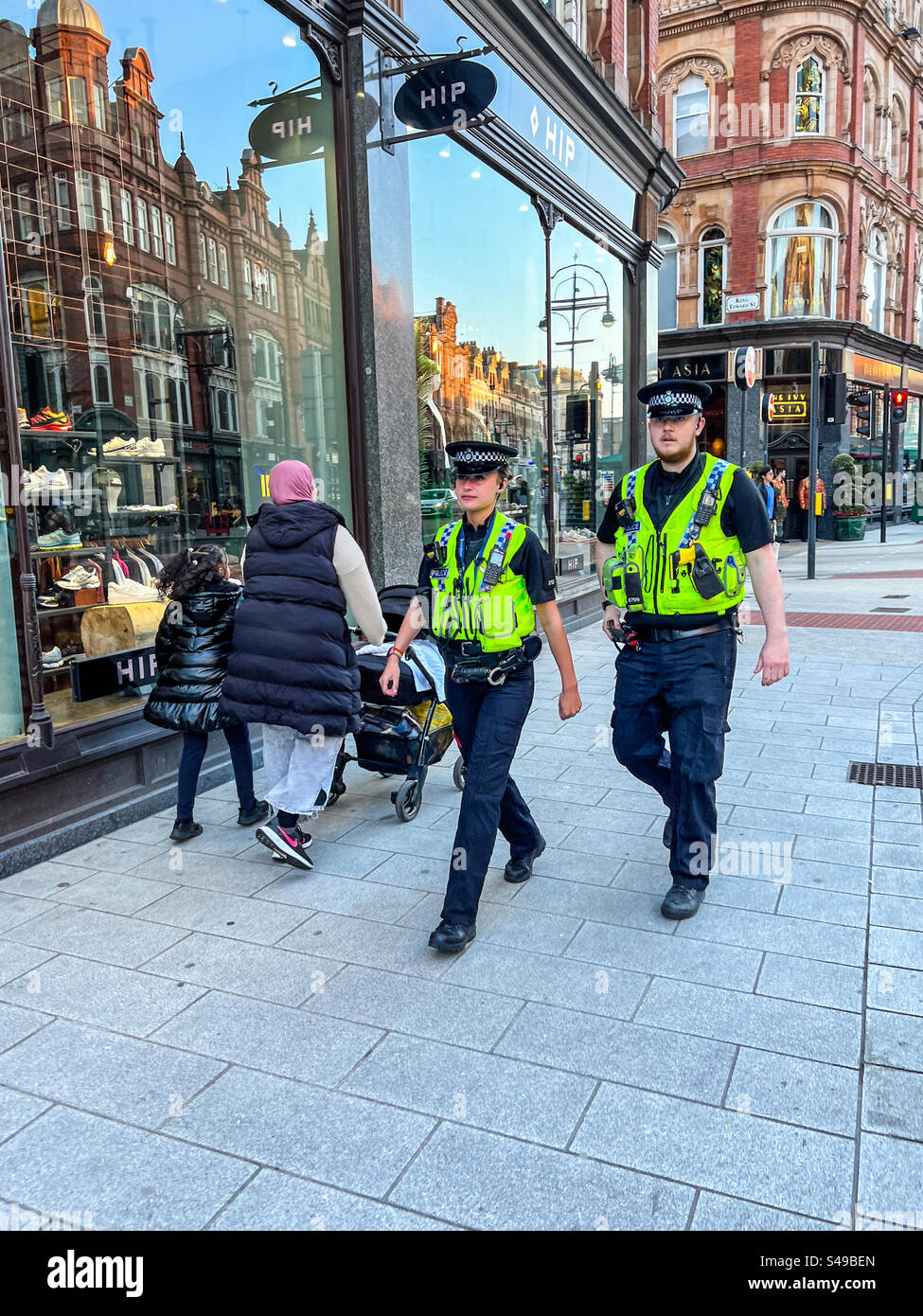 Police officers walking down Vicar Lane in Leeds city centre - Smartphone Captured Stock Image
