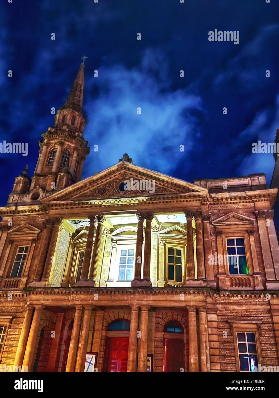 Hinde Street Methodist Church with spire and classical architecture frontage illuminated at night - design James Weir - c1880. Grade II Listed. Charles Wesley had lived in London nearby. - Smartphone Captured Stock Image