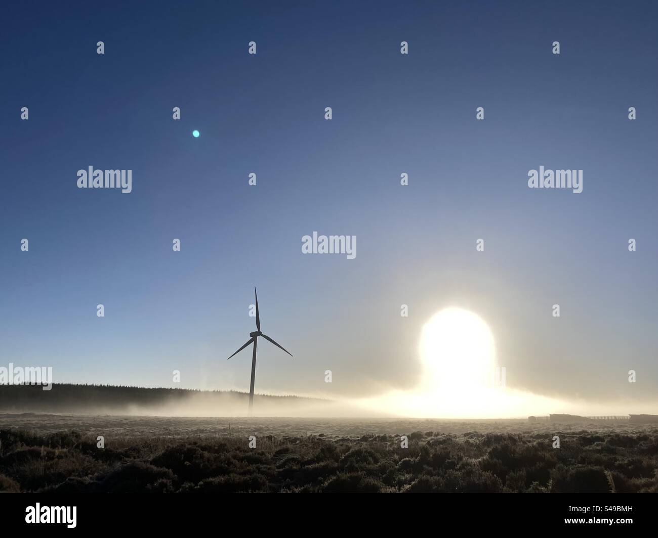 Wind turbine and winters sun with fog - Smartphone Captured Stock Image