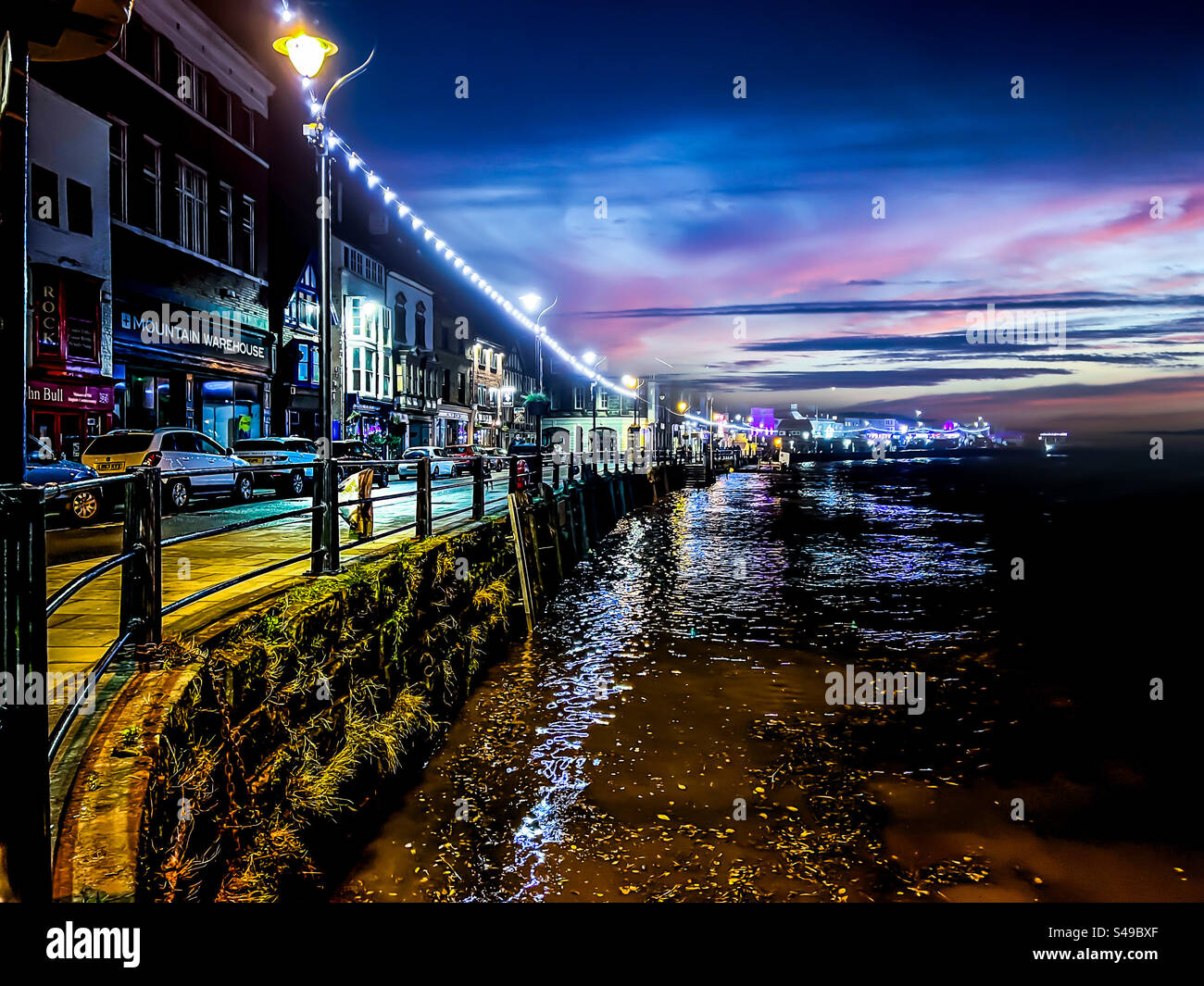 View down St Anne’s Staith street in Whitby town centre at night - Smartphone Captured Stock Image
