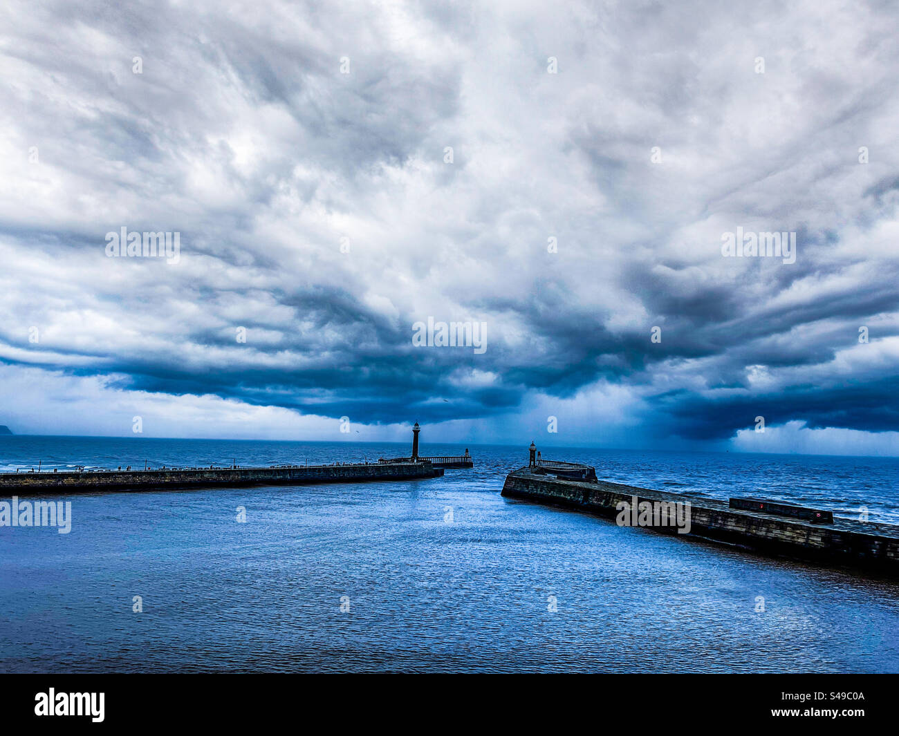 Whitby pier and the North Sea with storm clouds approaching - Smartphone Captured Stock Image