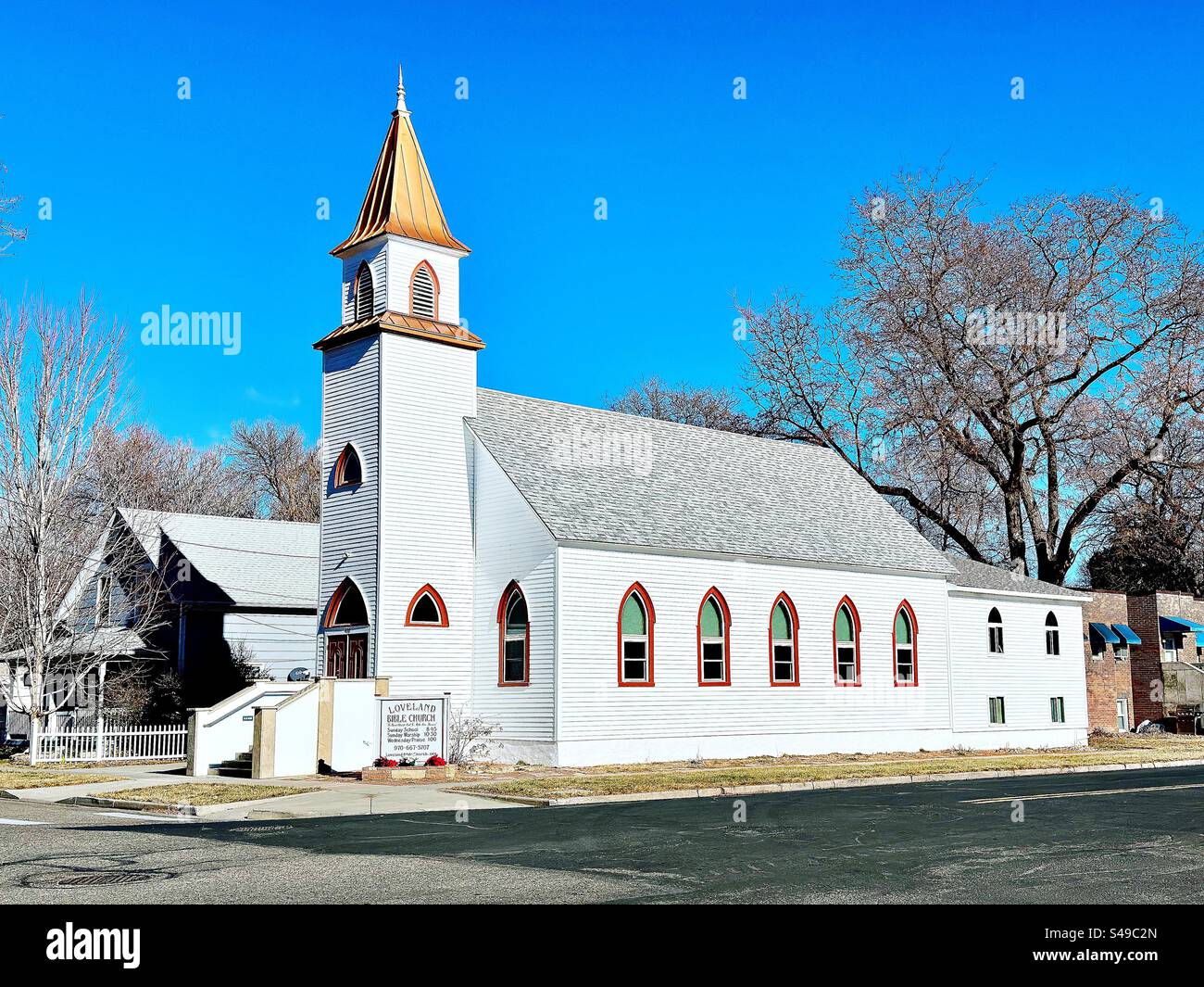Loveland, Colorado, USA: Exterior of Loveland Bible Church. White, wooden structure in historic, downtown area. - Smartphone Captured Stock Image