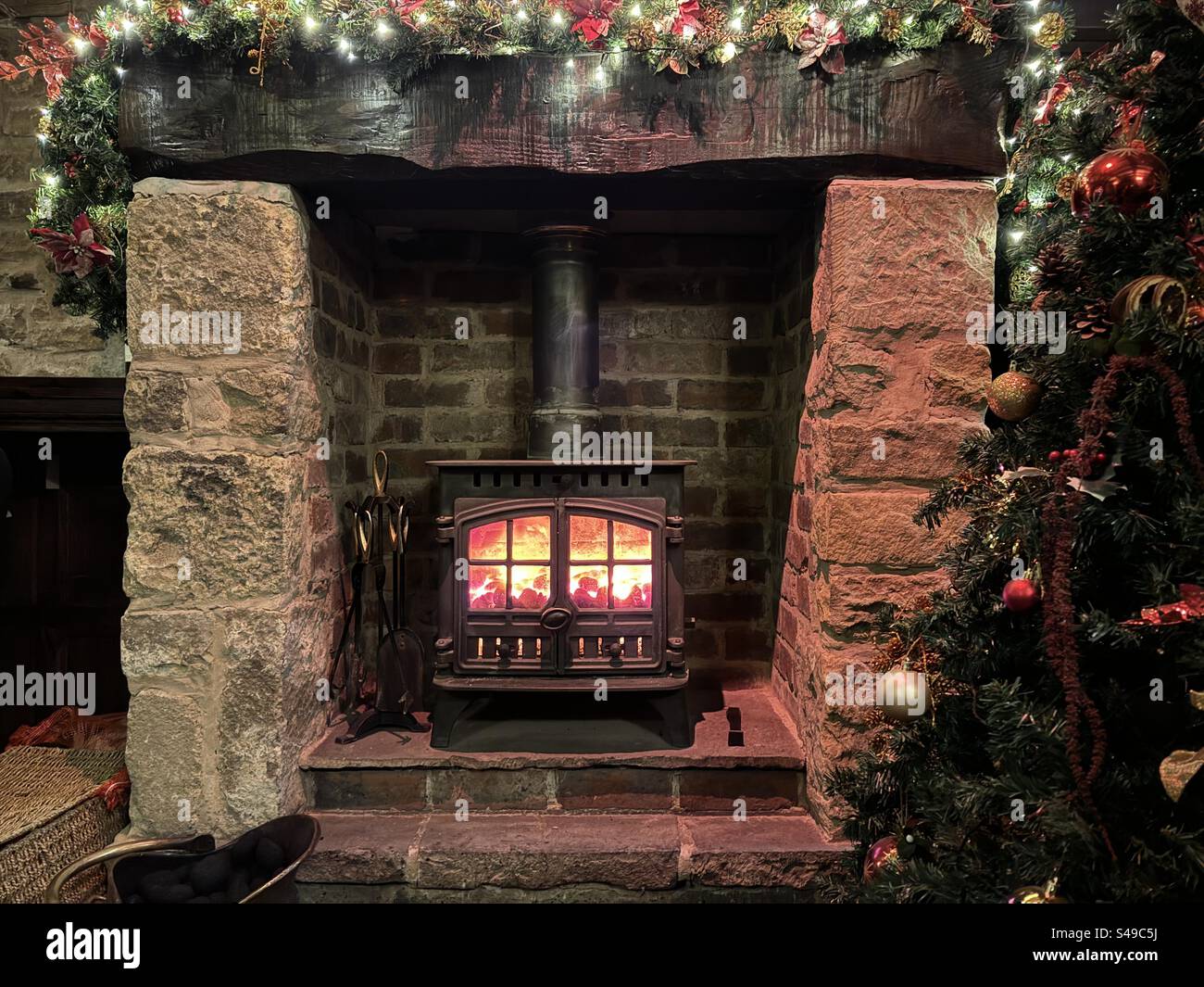 A cosy fireplace over the Christmas period Stock Photo