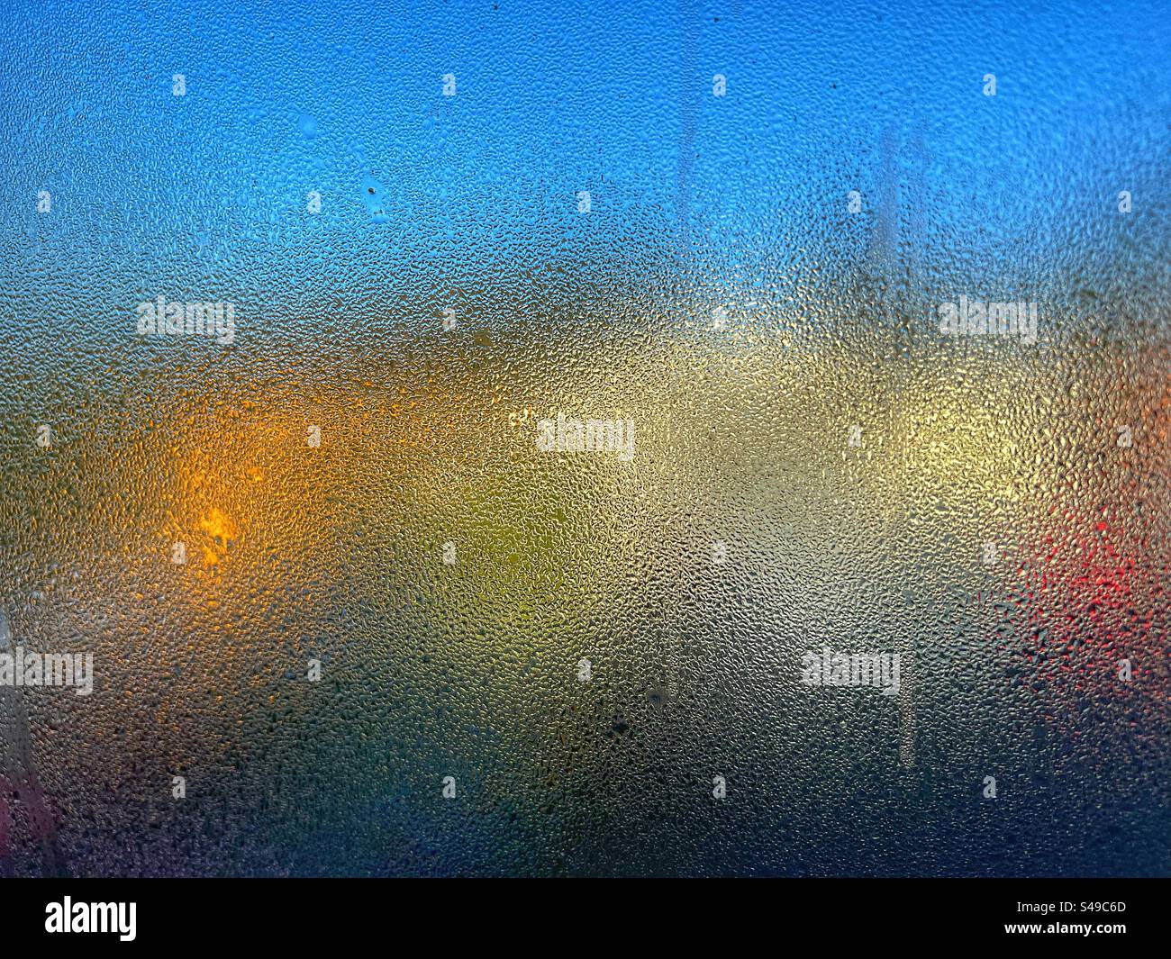 Bright colours seen in abstract through condensation on window - Smartphone Captured Stock Image