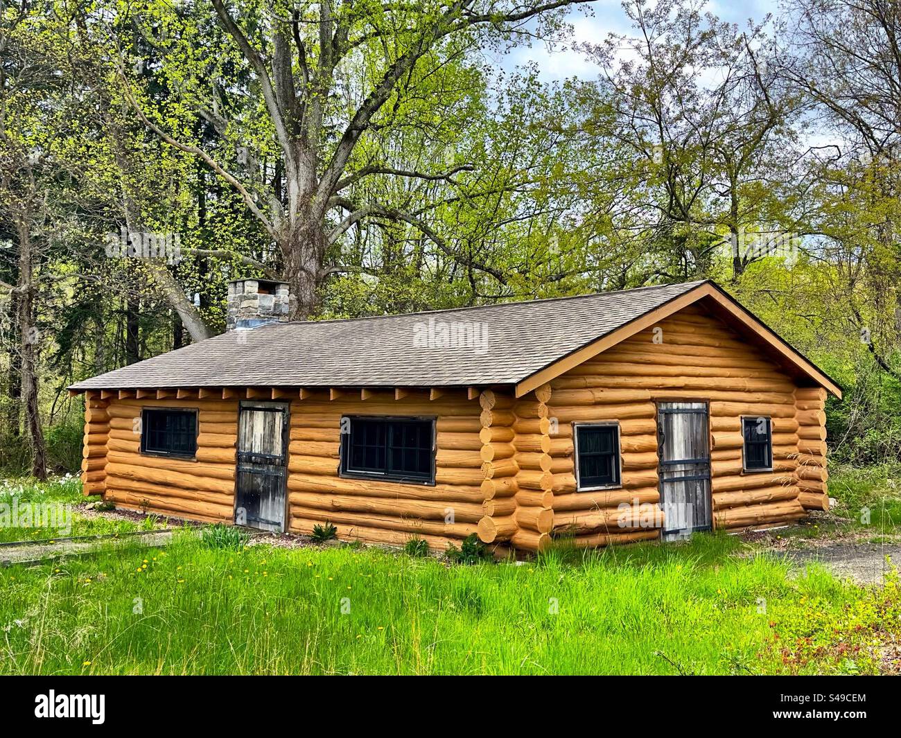 Log cabin at U.S. Fish and Wildlife Service Salt Meadow site in Westbrook, Connecticut, USA.  Stewart B. McKinney National Wildlife Refuge. - Smartphone Captured Stock Image