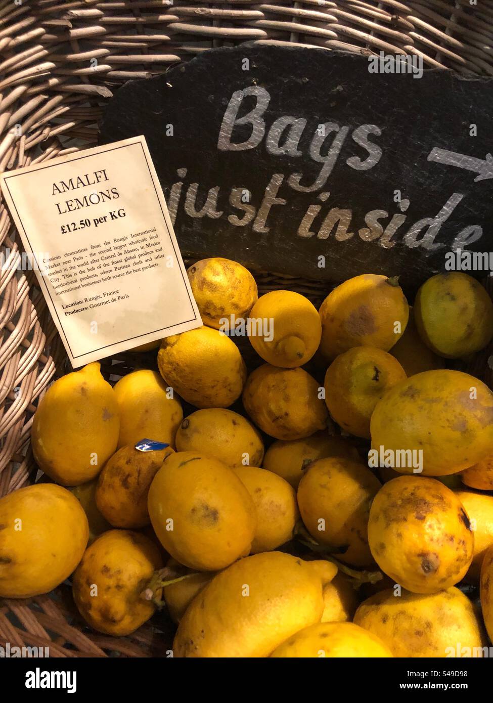Amalfi lemons priced up for sale at Grocers shop, citrus x limon Stock Photo
