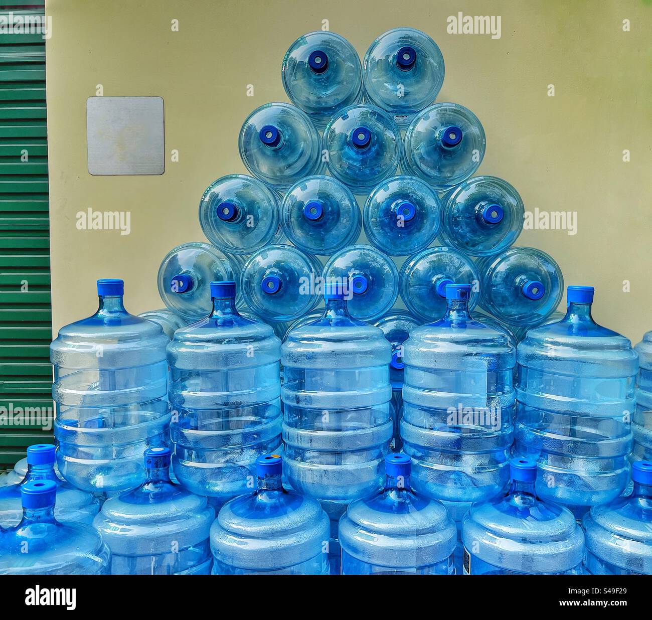 Stack of empty plastic water bottles in a warehouse - Smartphone Captured Stock Image