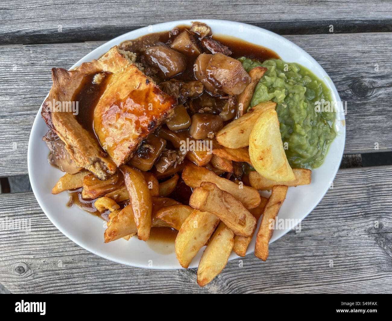 Meat and potato pie with chips and mushy peas - Smartphone Captured Stock Image