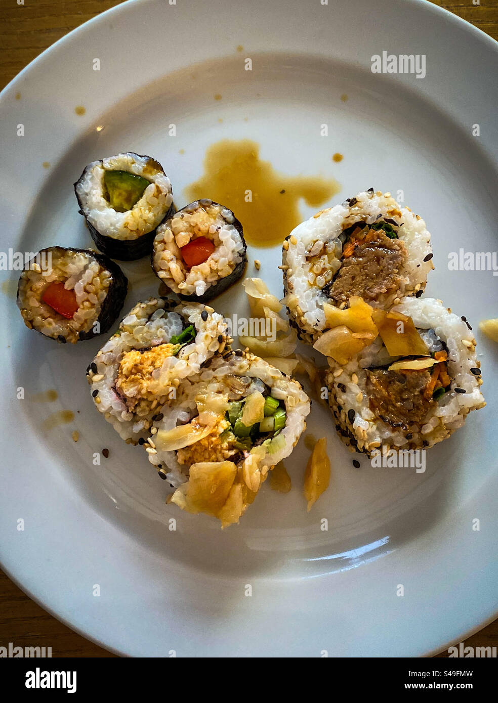 A very basic sushi lunch on a white plate - Smartphone Captured Stock Image