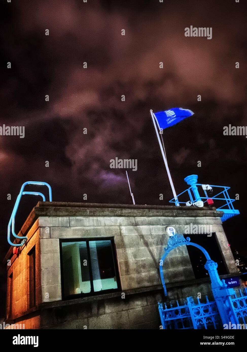 City Bridge Foundation this is the working name of the historic Bridge House Estates a trust maintains Tower Bridge and redistributes funds to worthy causes. The flag flying on Tower Bridge at night - Smartphone Captured Stock Image