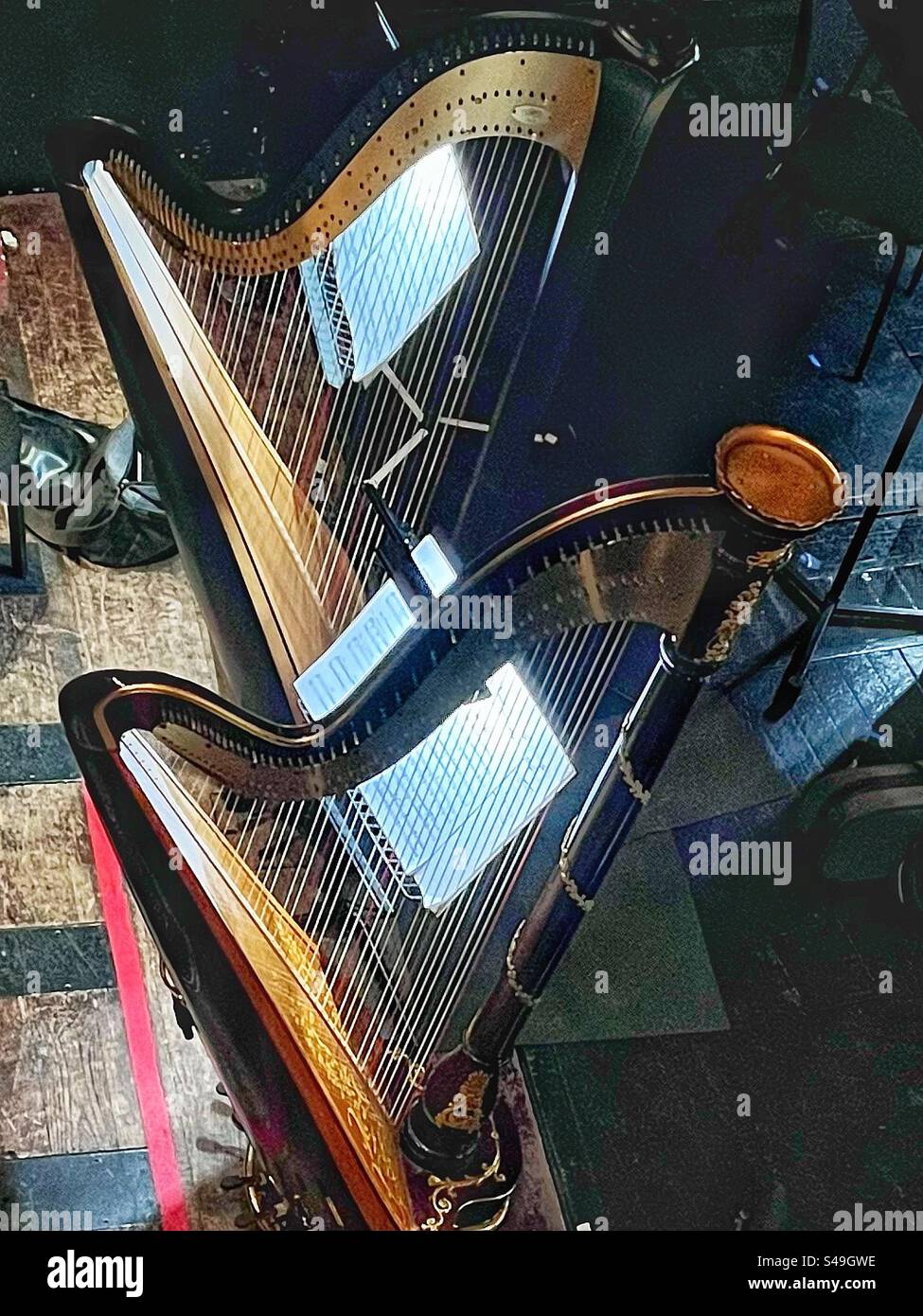 Two harps. Musical instruments in the orchestra seen at the Royal Opera House in London - Smartphone Captured Stock Image
