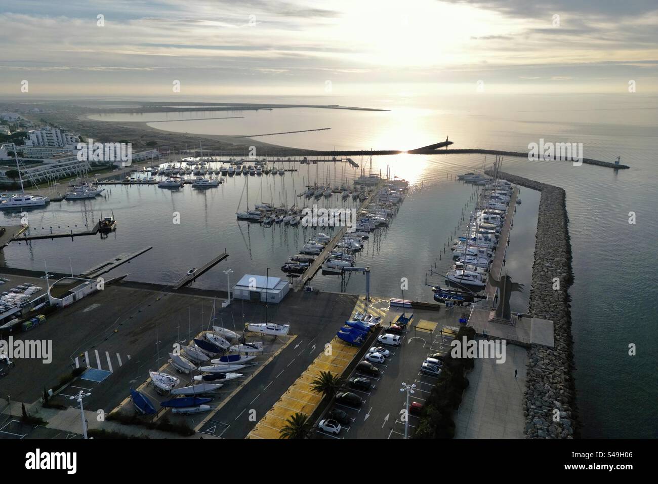 Aerial drone view of the sunset over the port and marina in Port Camargue, Occitanie, France. - Smartphone Captured Stock Image