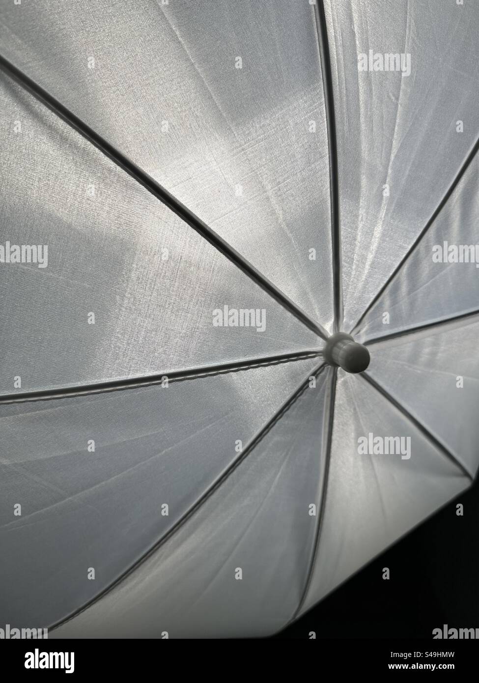 light shining through a white photography umbrella - Smartphone Captured Stock Image