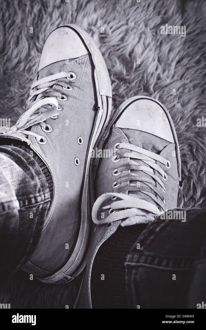 A pair of mens all star shoes on a furry rug - Smartphone Captured Stock Image