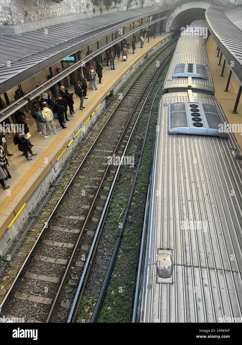 Train arriving at Monastiraki metro station in Athens, Greece, with people waiting on the platform. - Smartphone Captured Stock Image