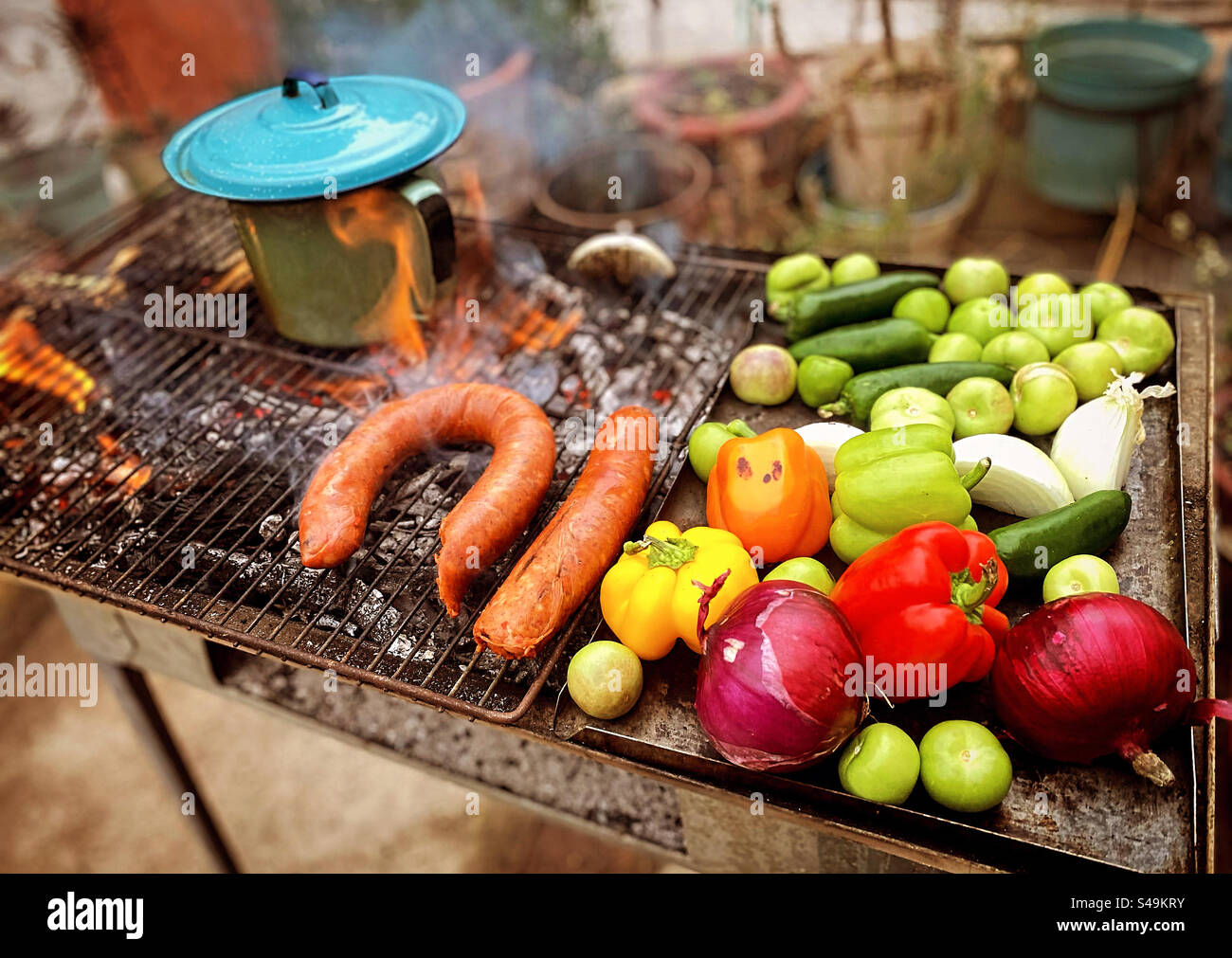 A Mexican carbon parrilla with a frijoles beans stew, green tomatoes