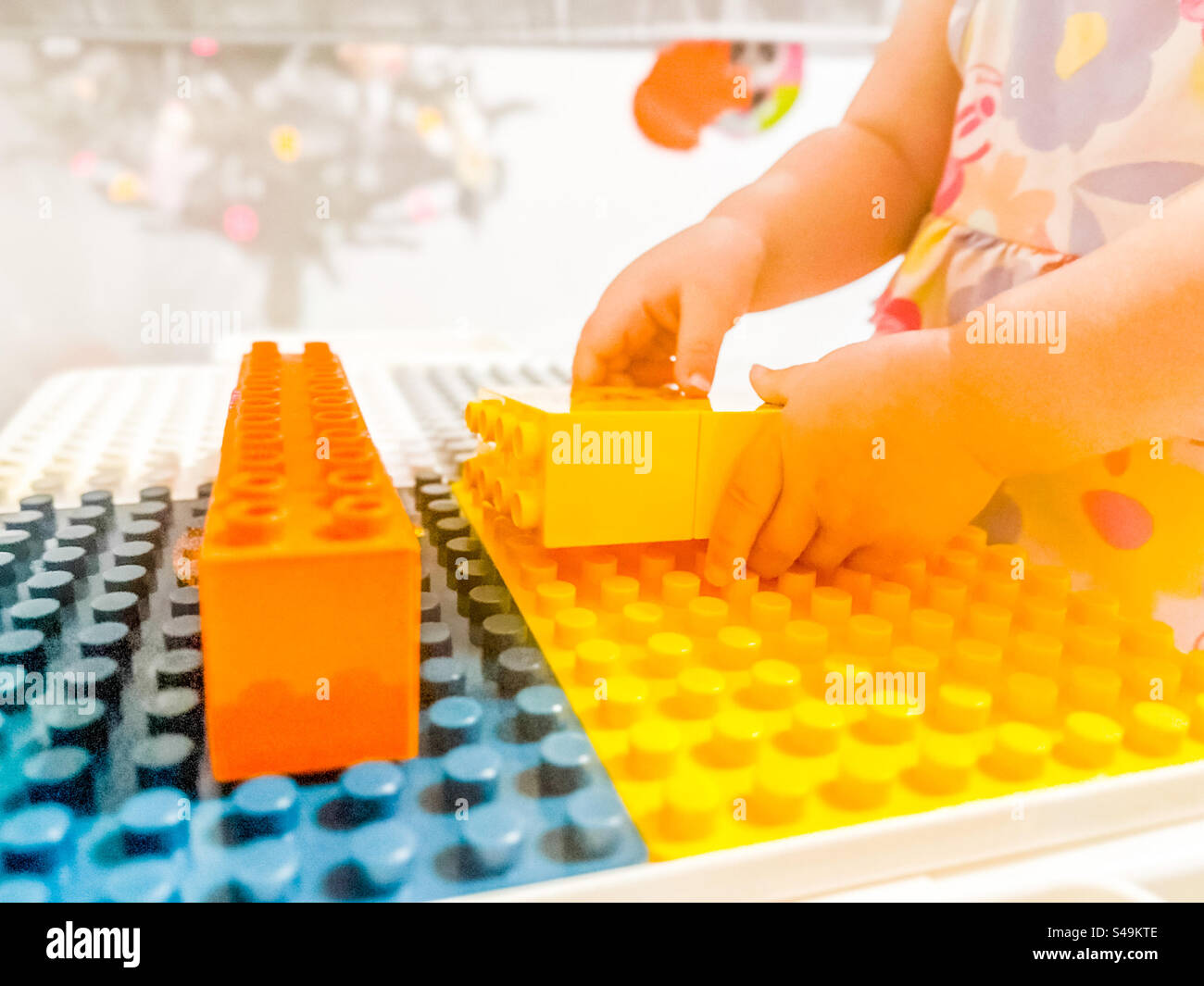 Toddlers hand playing with a construction set - Smartphone Captured Stock Image