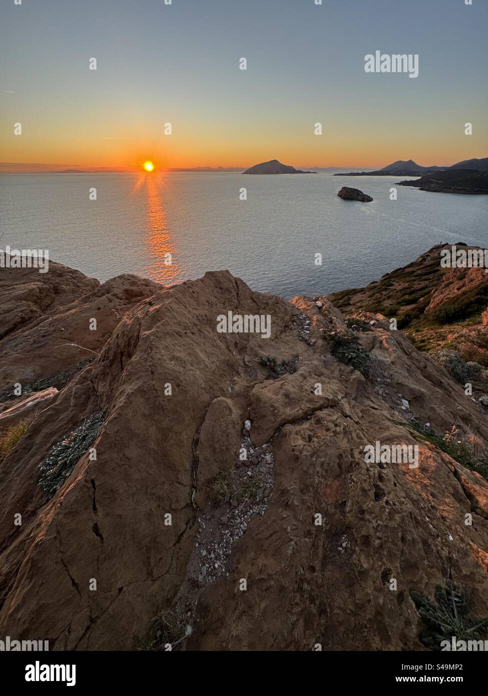 Sunset over the Aegean Sea from the archaeological site of the Temple of Poseidon, Cape Sounion, Greece. - Smartphone Captured Stock Image