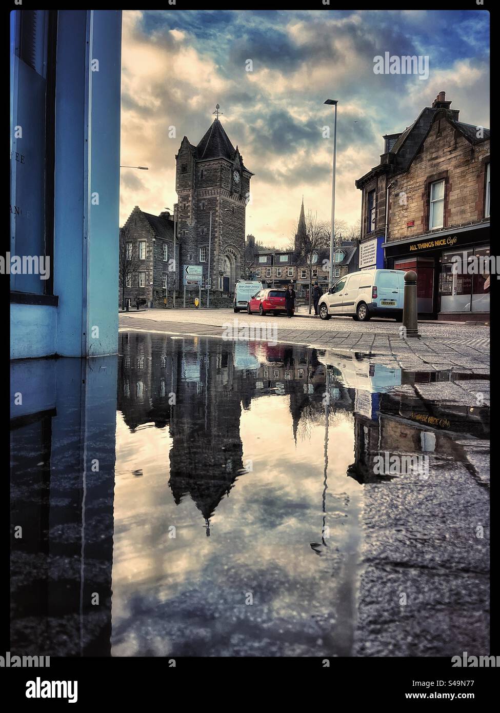 Galashiels council buildings, war memorial and clock with it reflected in a puddle. Stock Photo