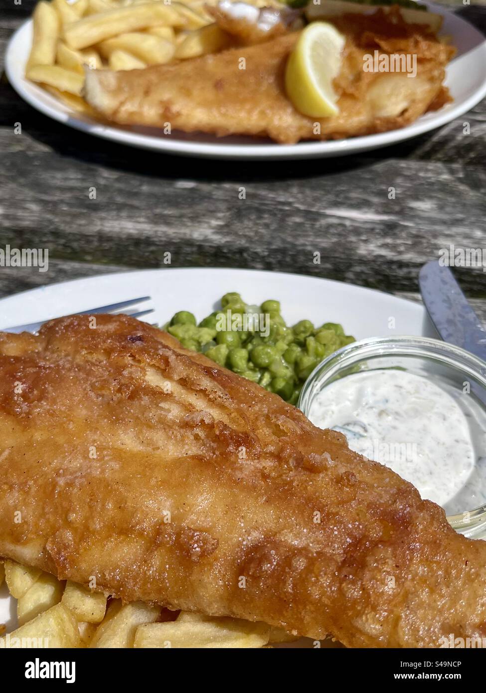Al fresco dining with traditional British fish and chips Stock Photo