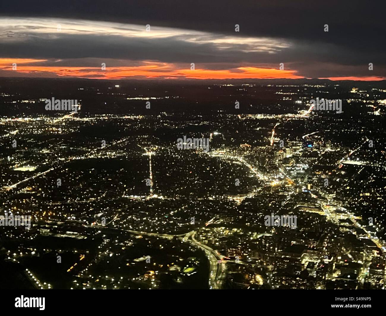 Aerial view of city lights speckling the landscape of Washington DC as night sets in. - Smartphone Captured Stock Image