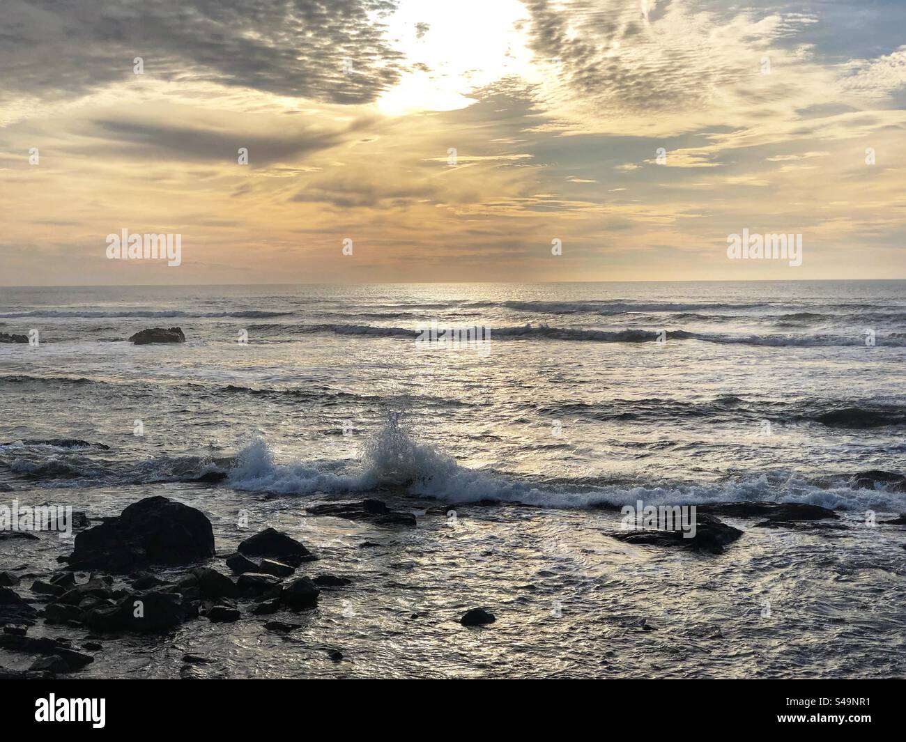 Wave breaking with a splash against rocks near Areosa, Viana do Castelo, Portugal, January 2024 - Smartphone Captured Stock Image