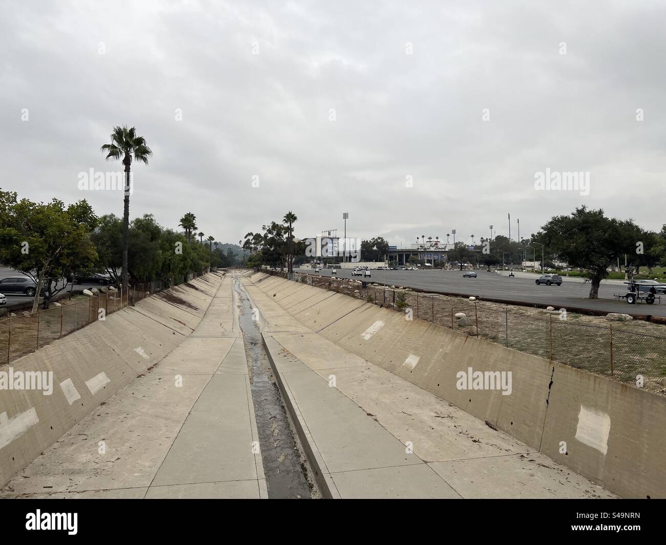 LOS ANGELES, CA, SEP 6, 2023, View along concrete-lined Arroyo Seco river, near the Rose Bowl Stadium in Pasadena, California, overcast sky above Stock Photo