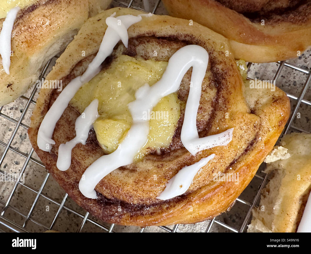Norwegian sonboller, skoleboller, sun buns, or sunshine buns are made of a cardamom dough which is rolled with cinnamon and sugar, and the center filled with egg custard. - Smartphone Captured Stock Image
