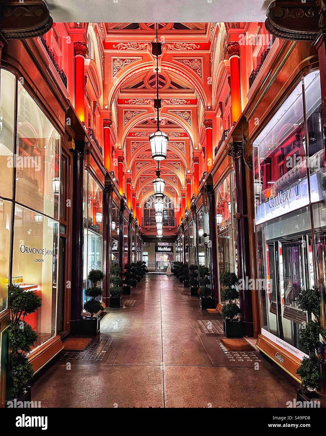 The Royal Arcade is a Victorian shopping centre in the heart of London. Curved glass windows and lighting make it an attractive place to browse and buy - an exemplar in architectural design. - Smartphone Captured Stock Image